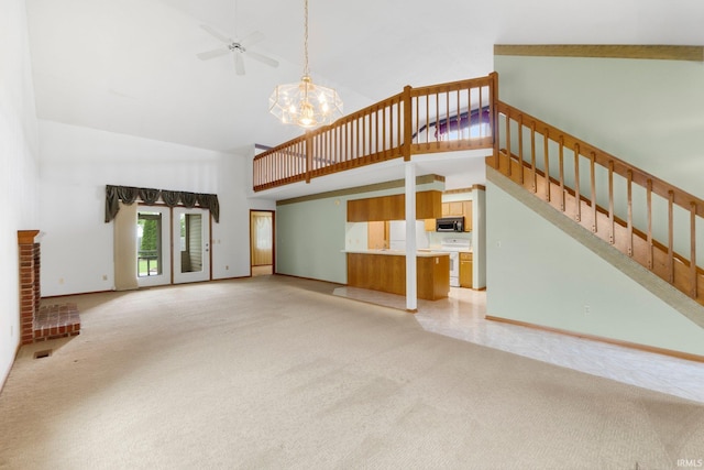 2223 Old Auburn Cv, Fort Wayne, IN 46845 - unfurnished living room featuring high vaulted ceiling, light carpet, a chandelier, stairs, and baseboards
