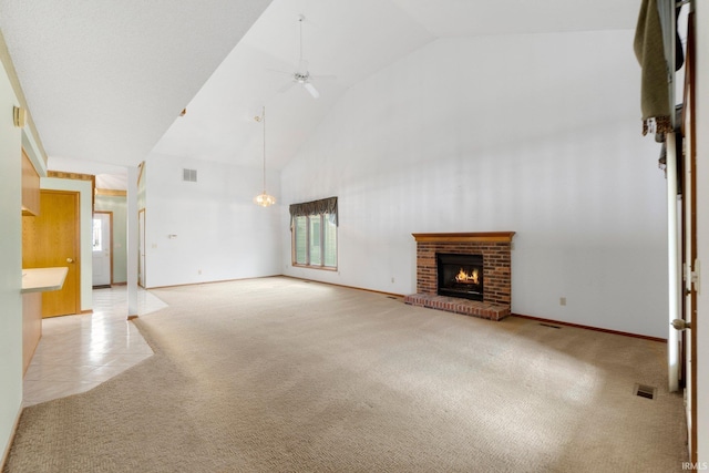 2223 Old Auburn Cv, Fort Wayne, IN 46845 - unfurnished living room featuring healthy amount of natural light, light carpet, high vaulted ceiling, a fireplace, and ceiling fan