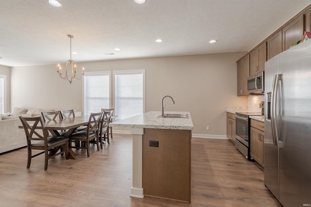 4755 Eastwick Dr, Newburgh, IN 47630 - kitchen featuring stainless steel appliances, a sink, recessed lighting, plenty of natural light, and a kitchen island with sink