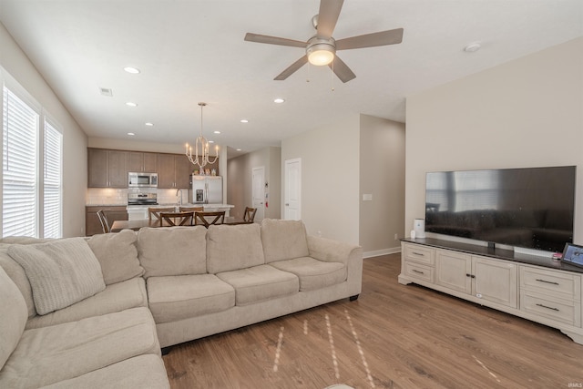 4755 Eastwick Dr, Newburgh, IN 47630 - living area featuring a chandelier, recessed lighting, wood finished floors, ceiling fan, and baseboards