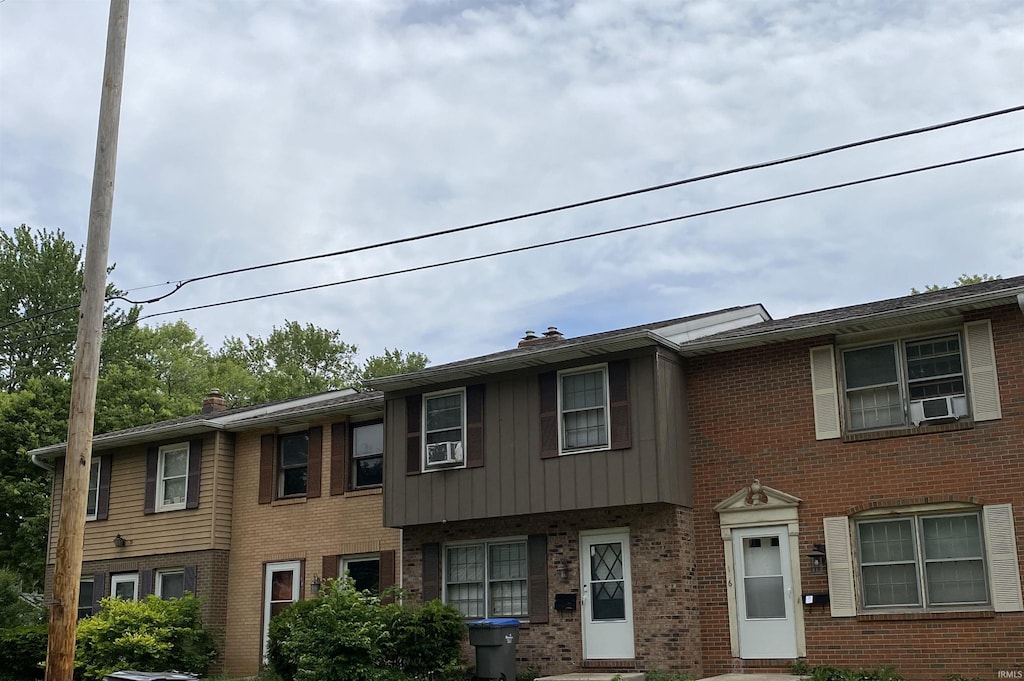100 S Michigan St, Elkhart, IN 46514 - townhome / multi-family property with brick siding, cooling unit, and a chimney
