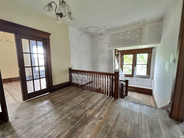 806 E Market St, Logansport, IN 46947 - unfurnished room featuring a chandelier, hardwood / wood-style floors, and healthy amount of natural light