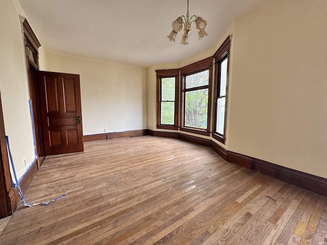 806 E Market St, Logansport, IN 46947 - spare room with a chandelier, light wood finished floors, and baseboards