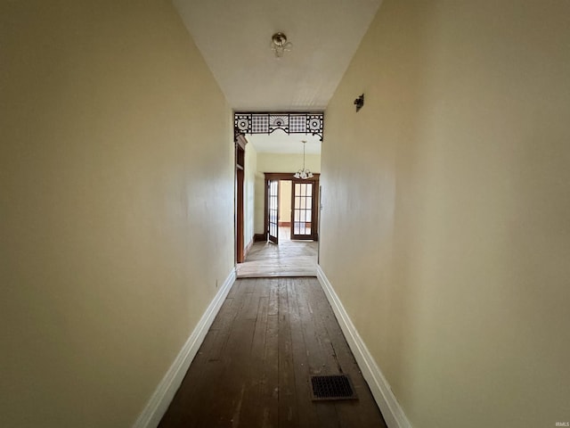806 E Market St, Logansport, IN 46947 - hallway with a chandelier, dark wood finished floors, and baseboards