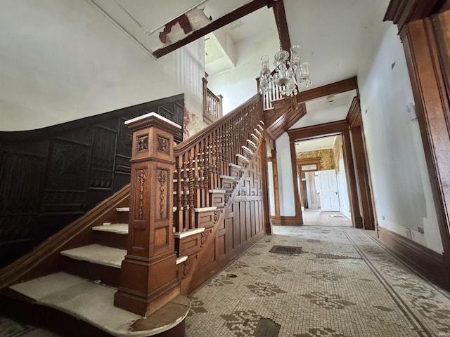 806 E Market St, Logansport, IN 46947 - stairway featuring a high ceiling, a chandelier, and carpet floors