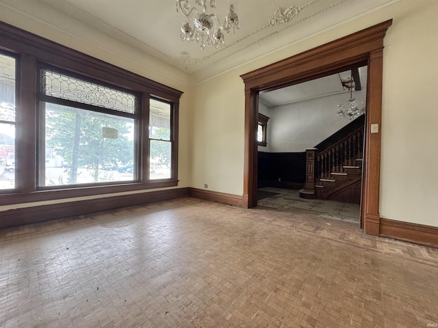 806 E Market St, Logansport, IN 46947 - spare room featuring a chandelier, stairway, and baseboards