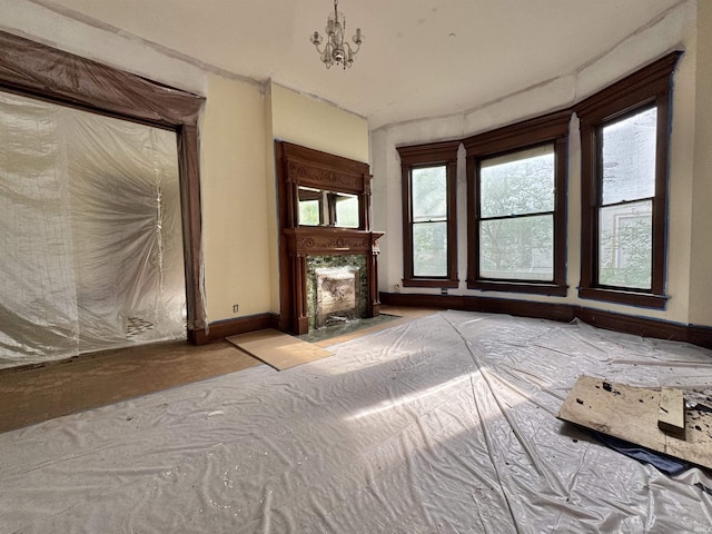 806 E Market St, Logansport, IN 46947 - unfurnished living room featuring plenty of natural light, baseboards, and a fireplace with flush hearth
