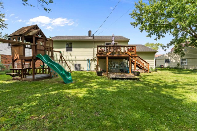 1804 Saint Charles Ct, Kokomo, IN 46902 - back of property with stairs, a wooden deck, a playground, and a yard