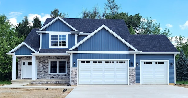 2022 W Blackberry Trl, Warsaw, IN 46582 - craftsman-style house featuring an attached garage, driveway, stone siding, a porch, and a shingled roof