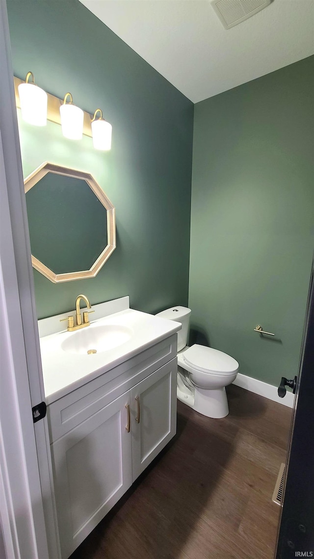 2022 W Blackberry Trl, Warsaw, IN 46582 - half bath with wood finished floors, vanity, toilet, and baseboards