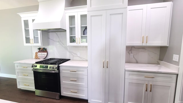 2022 W Blackberry Trl, Warsaw, IN 46582 - kitchen featuring gas range, custom exhaust hood, decorative backsplash, glass insert cabinets, and light stone counters