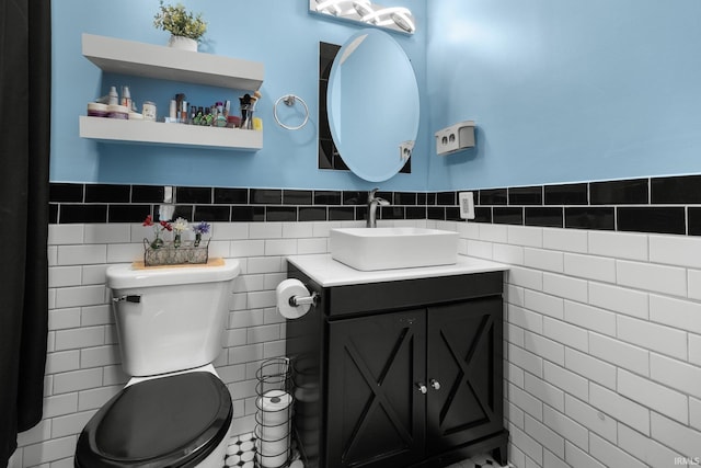 3739 S Westmont Ave, Bloomington, IN 47403 - half bath featuring tile walls, vanity, toilet, and wainscoting