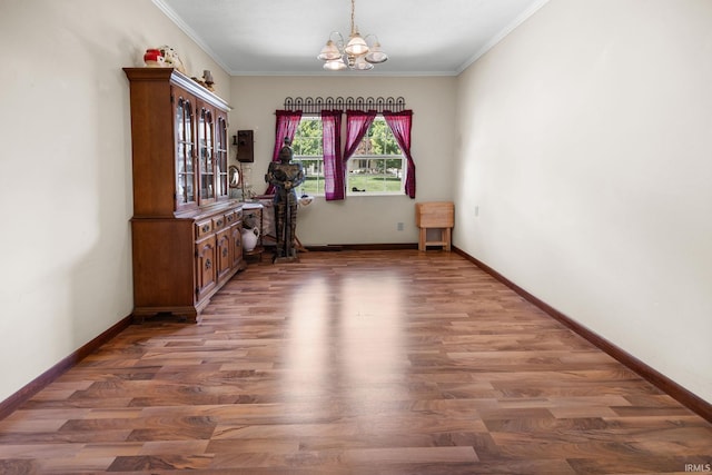 3739 S Westmont Ave, Bloomington, IN 47403 - unfurnished dining area with a chandelier, light wood-style floors, ornamental molding, and baseboards