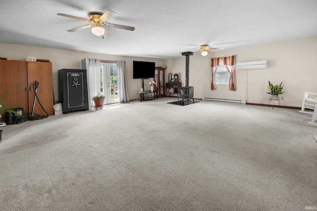 3739 S Westmont Ave, Bloomington, IN 47403 - unfurnished living room with ceiling fan, an AC wall unit, a wood stove, and plenty of natural light