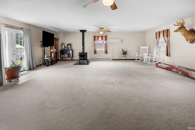 3739 S Westmont Ave, Bloomington, IN 47403 - living room featuring a baseboard heating unit, plenty of natural light, a wood stove, and carpet flooring