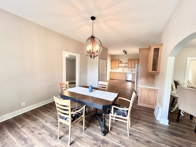 604 W Franklin St, Colfax, IN 46035 - dining area with arched walkways, a chandelier, dark wood finished floors, and baseboards