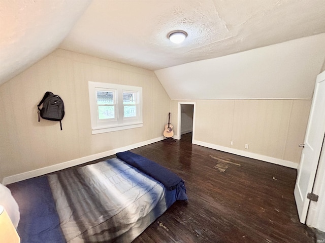 604 W Franklin St, Colfax, IN 46035 - unfurnished bedroom featuring wood finished floors, lofted ceiling, and baseboards