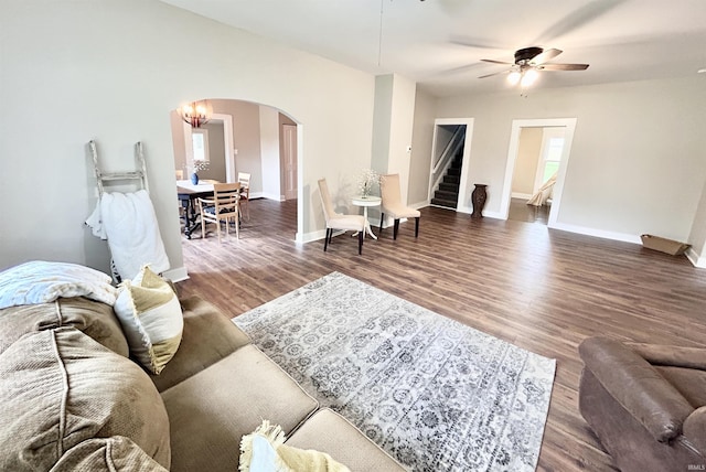 604 W Franklin St, Colfax, IN 46035 - living area with arched walkways, stairs, ceiling fan, wood finished floors, and baseboards