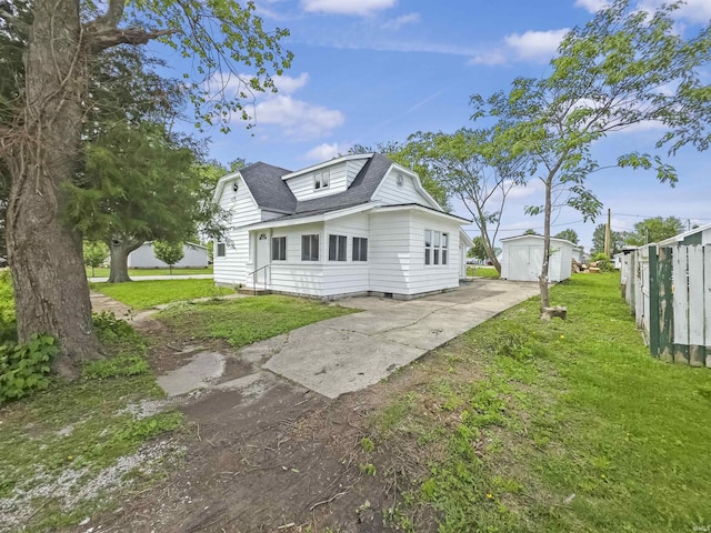 290 NW G St, Linton, IN 47441 - back of house with concrete driveway, an outbuilding, and roof with shingles