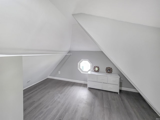 290 NW G St, Linton, IN 47441 - additional living space with vaulted ceiling, dark wood-style flooring, and baseboards