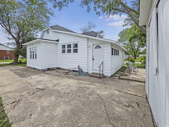 290 NW G St, Linton, IN 47441 - rear view of property with entry steps, a patio, and roof with shingles