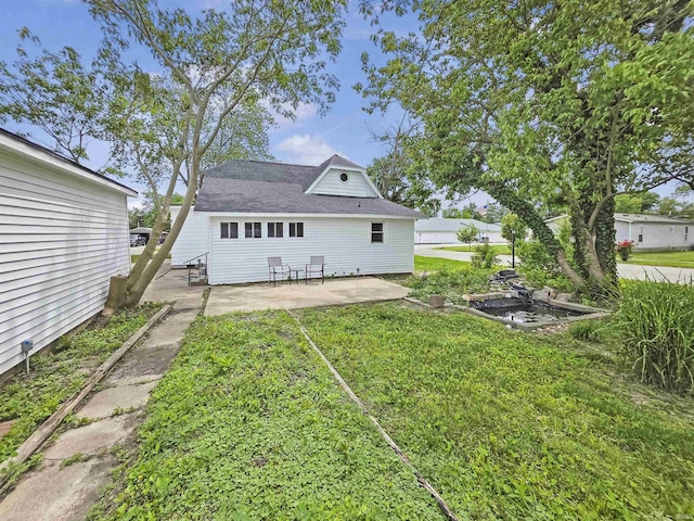 290 NW G St, Linton, IN 47441 - rear view of house with a patio area, a yard, and roof with shingles