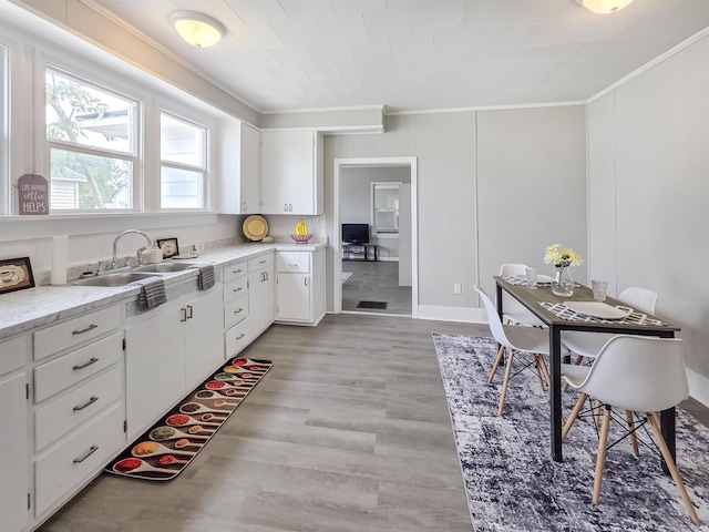290 NW G St, Linton, IN 47441 - kitchen with ornamental molding, a sink, white cabinets, light wood-style floors, and baseboards