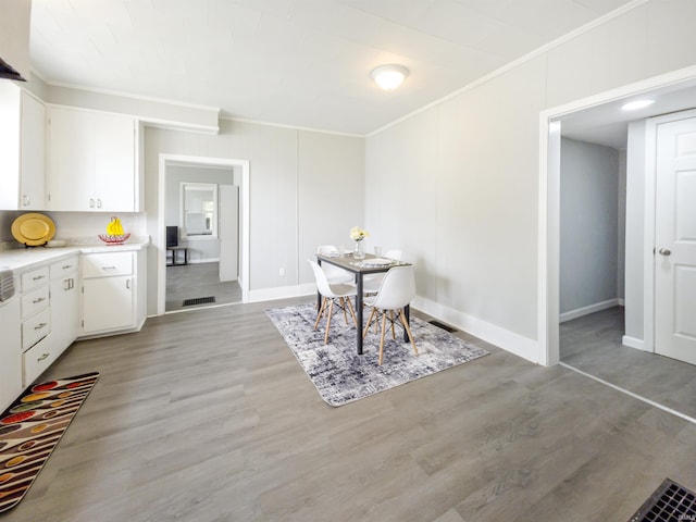 290 NW G St, Linton, IN 47441 - dining space featuring crown molding, light wood-style floors, and baseboards