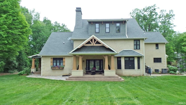 113 Lakewood Dr, Vincennes, IN 47591 - back of property featuring french doors, a chimney, a lawn, and roof with shingles