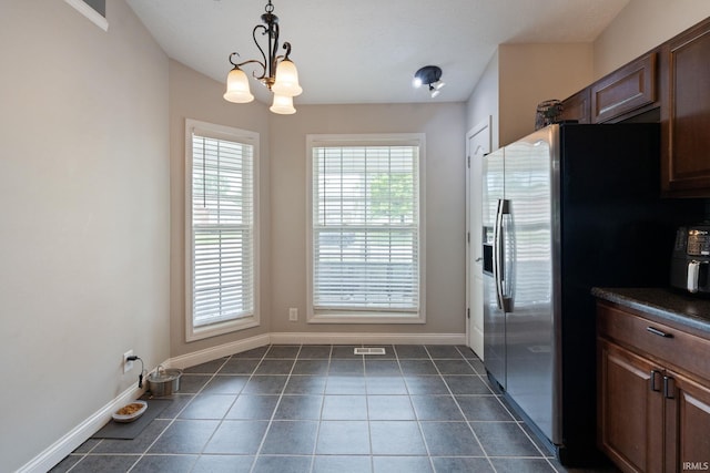1606 Waverly Dr, Lafayette, IN 47909 - kitchen featuring stainless steel fridge, plenty of natural light, dark countertops, and baseboards
