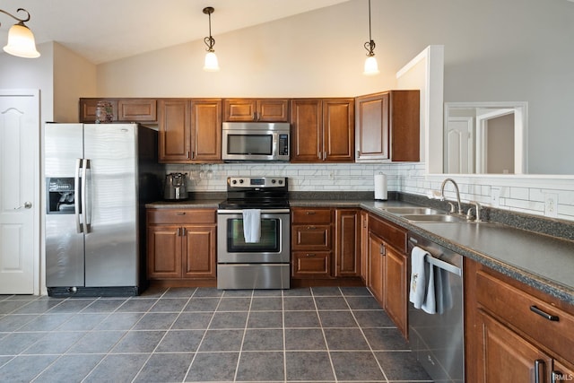 1606 Waverly Dr, Lafayette, IN 47909 - kitchen featuring appliances with stainless steel finishes, lofted ceiling, a sink, dark countertops, and decorative backsplash