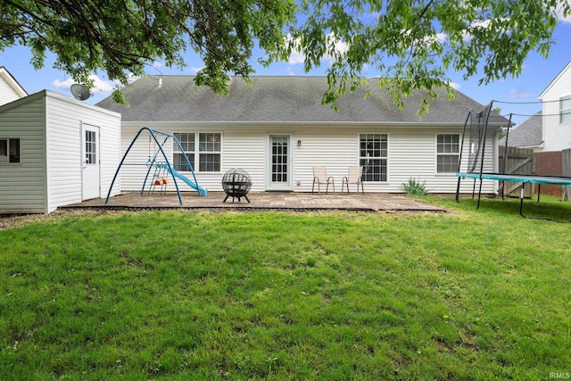 1606 Waverly Dr, Lafayette, IN 47909 - rear view of property featuring a trampoline, a patio, and roof with shingles