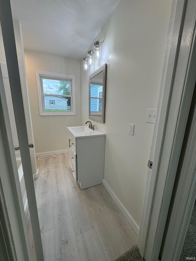 6701 E Hickory Ln, Muncie, IN 47303 - bathroom featuring vanity, wood finished floors, and baseboards