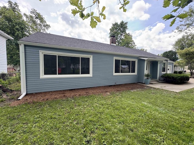 6701 E Hickory Ln, Muncie, IN 47303 - view of front of home with a chimney, a front yard, and a patio