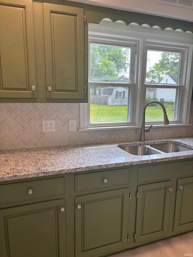 6701 E Hickory Ln, Muncie, IN 47303 - kitchen featuring green cabinets, a sink, and decorative backsplash