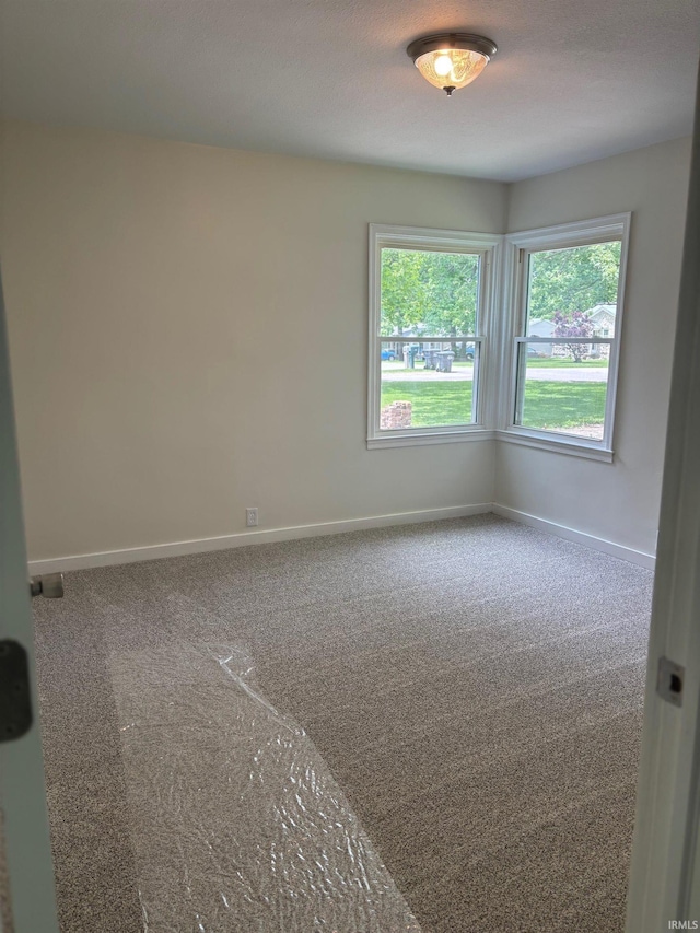 6701 E Hickory Ln, Muncie, IN 47303 - spare room featuring carpet flooring and baseboards
