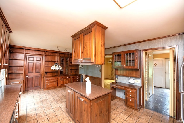 1301 E 4th St, Fowler, IN 47944 - kitchen with open shelves, crown molding, brown cabinets, light stone finish floors, and a kitchen island