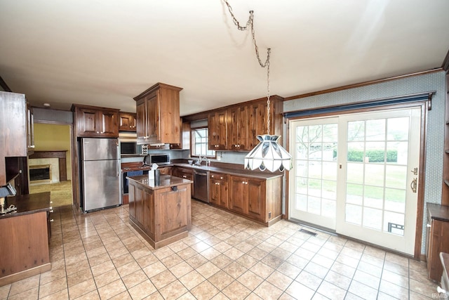 1301 E 4th St, Fowler, IN 47944 - kitchen with stainless steel appliances, dark countertops, a sink, and a kitchen island