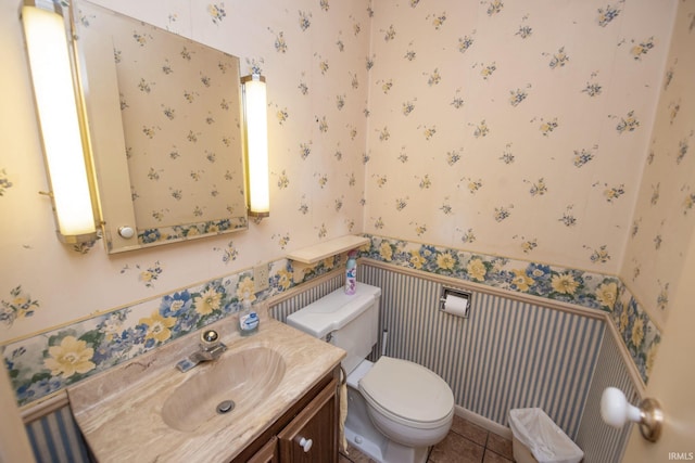 1301 E 4th St, Fowler, IN 47944 - bathroom featuring wallpapered walls, toilet, vanity, wainscoting, and tile patterned flooring