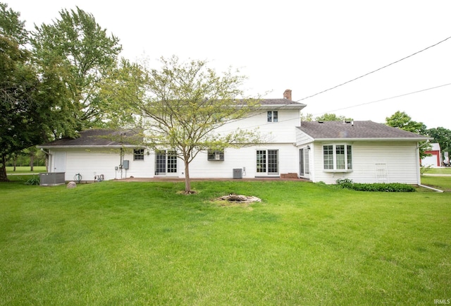 1301 E 4th St, Fowler, IN 47944 - rear view of house with a chimney, a lawn, and central AC unit