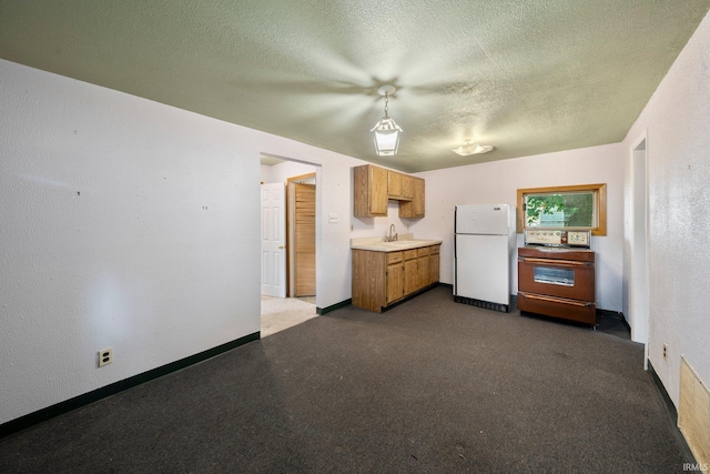 51662 Kenilworth Rd, South Bend, IN 46637 - kitchen featuring freestanding refrigerator, range, a sink, light countertops, and a textured ceiling