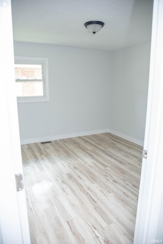 1105 W Tilmor Dr, Muncie, IN 47303 - empty room featuring wood finished floors and baseboards