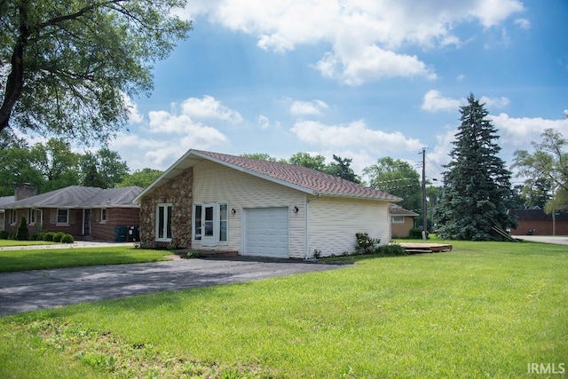 1105 W Tilmor Dr, Muncie, IN 47303 - view of property exterior featuring an attached garage, driveway, a lawn, and stone siding