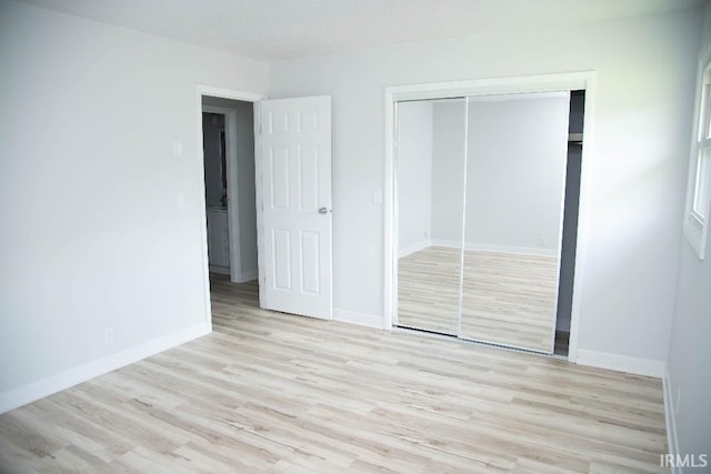 1105 W Tilmor Dr, Muncie, IN 47303 - unfurnished bedroom featuring light wood finished floors, a closet, and baseboards