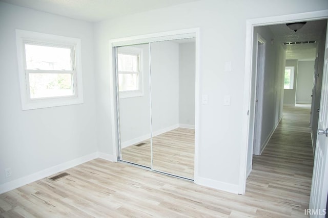 1105 W Tilmor Dr, Muncie, IN 47303 - unfurnished bedroom featuring a closet, light wood finished floors, and baseboards
