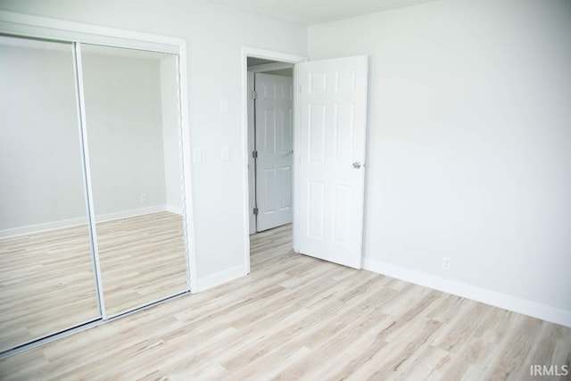 1105 W Tilmor Dr, Muncie, IN 47303 - unfurnished bedroom featuring wood finished floors, a closet, and baseboards