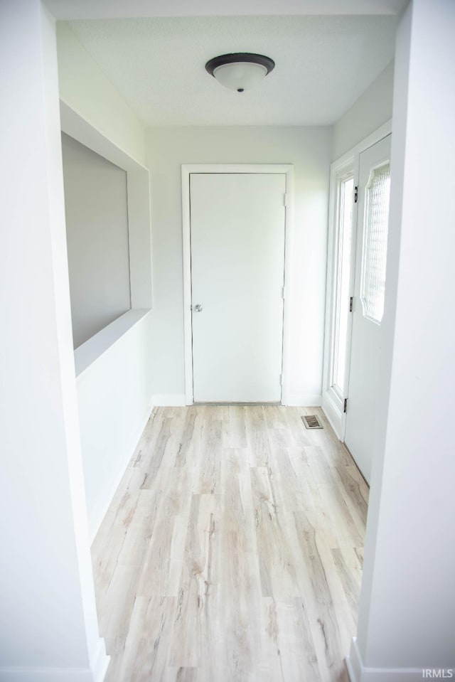 1105 W Tilmor Dr, Muncie, IN 47303 - hallway with wood finished floors and baseboards