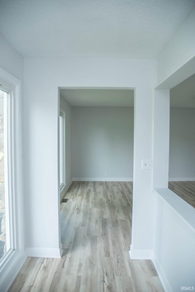 1105 W Tilmor Dr, Muncie, IN 47303 - corridor featuring wood finished floors and baseboards