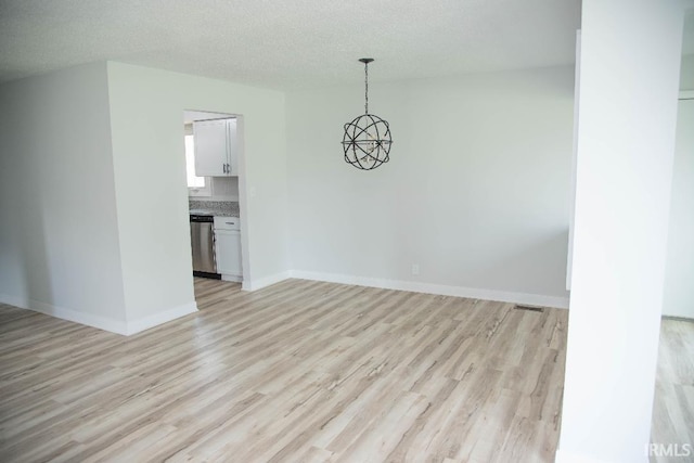 1105 W Tilmor Dr, Muncie, IN 47303 - unfurnished dining area with light wood-type flooring, a chandelier, baseboards, and a textured ceiling
