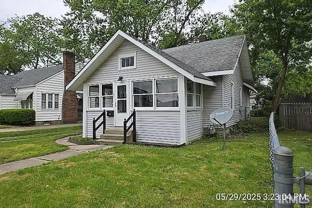 121 Altgeld St, South Bend, IN 46614 - bungalow-style house featuring entry steps, roof with shingles, and a chimney